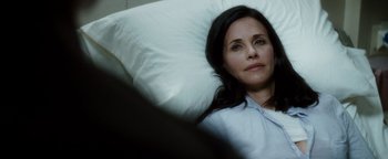 Movie still from “Scream 4” (2011), directed by Wes Craven – A woman laying in a bed with a white pillow; Close Up shot, High angle