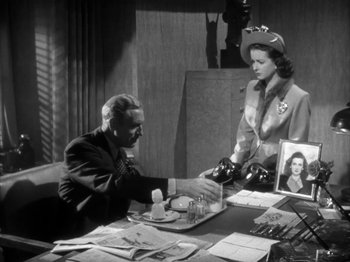 Movie still from “Secret Beyond the Door...” (1947), directed by Fritz Lang – A man and a woman sitting at a table; Medium shot, High angle