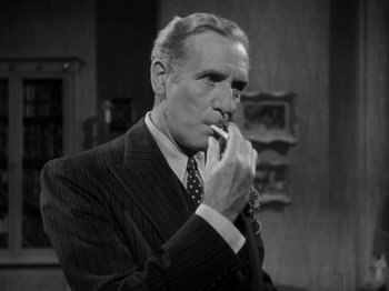 Movie still from “Secret Beyond the Door...” (1947), directed by Fritz Lang – An older man smoking a cigarette while wearing a suit and tie; Close Up shot, Low angle