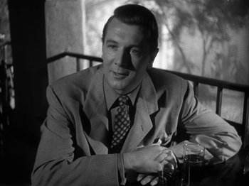 Movie still from “Secret Beyond the Door...” (1947), directed by Fritz Lang – A black and white photo of a man wearing a suit and tie; Close Up shot, Low angle