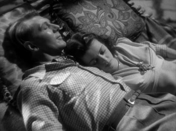 Movie still from “Secret Beyond the Door...” (1947), directed by Fritz Lang – A man and a woman sleeping on a couch; Medium shot, Overhead angle