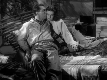 Movie still from “Secret Beyond the Door...” (1947), directed by Fritz Lang – A man and a woman sitting on a bed together; Medium shot, Low angle