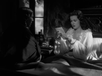 Movie still from “Secret Beyond the Door...” (1947), directed by Fritz Lang – Two women sitting on a bed looking at a book; Medium shot, Over the shoulder angle