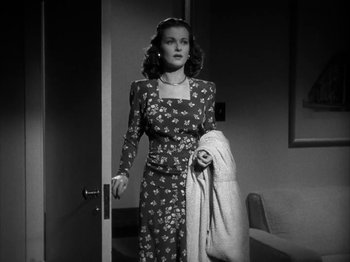 Movie still from “Secret Beyond the Door...” (1947), directed by Fritz Lang – A black and white photo of a woman in a dress; Medium shot, High angle