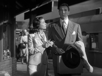 Movie still from “Secret Beyond the Door...” (1947), directed by Fritz Lang – A man and a woman standing next to each other on the street; Medium shot, Low angle