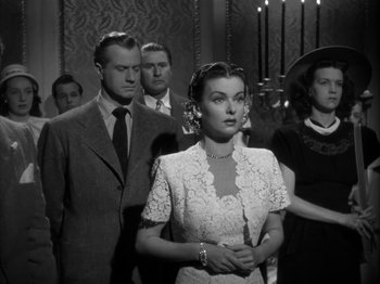 Movie still from “Secret Beyond the Door...” (1947), directed by Fritz Lang – A group of men and women standing in a room; Medium shot, Low angle