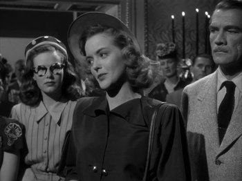 Movie still from “Secret Beyond the Door...” (1947), directed by Fritz Lang – A group of people standing next to each other in a room; Medium shot, Low angle