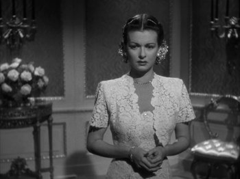 Movie still from “Secret Beyond the Door...” (1947), directed by Fritz Lang – A black and white photo of a woman in a white dress; Close Up shot, Over the shoulder angle