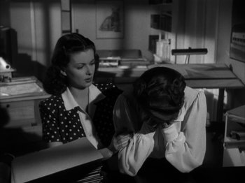 Movie still from “Secret Beyond the Door...” (1947), directed by Fritz Lang – A woman sitting at a desk next to another woman; Medium shot, High angle