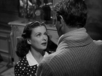 Movie still from “Secret Beyond the Door...” (1947), directed by Fritz Lang – An old photo of a man and a woman talking; Close Up shot, Over the shoulder angle