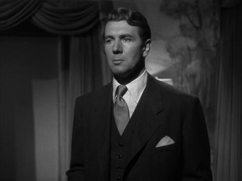 Movie still from “Secret Beyond the Door...” (1947), directed by Fritz Lang – A black and white photo of a man in a suit and tie; Close Up shot, Low angle