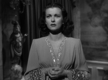 Movie still from “Secret Beyond the Door...” (1947), directed by Fritz Lang – A black - and - white photo of a woman in a dress; Close Up shot, Low angle