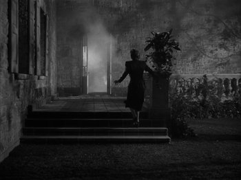 Movie still from “Secret Beyond the Door...” (1947), directed by Fritz Lang – A woman walking down the steps of a building; Extreme Wide shot, High angle