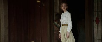 Movie still from “Godless” (2017), directed by Scott Frank – A woman in a white shirt and a beige skirt; Medium shot, Over the shoulder angle