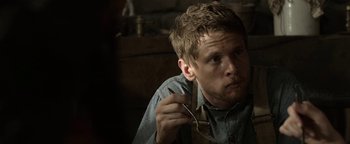Movie still from “Godless” (2017), directed by Scott Frank – A man holding a pair of glasses in his hand; Close Up shot, Over the shoulder angle