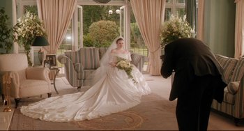 Movie still from “Secrets & Lies” (1996), directed by Mike Leigh – A woman in a wedding dress in front of a man in a suit; Wide shot, High angle