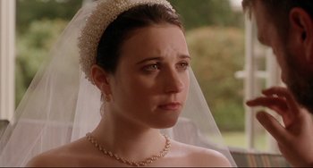 Movie still from “Secrets & Lies” (1996), directed by Mike Leigh – A woman wearing a tiara and a veil looking sad; Close Up shot, Over the shoulder angle