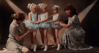 Movie still from “Secrets & Lies” (1996), directed by Mike Leigh – Three little ballerinas are being taught by a teacher; Medium shot, High angle