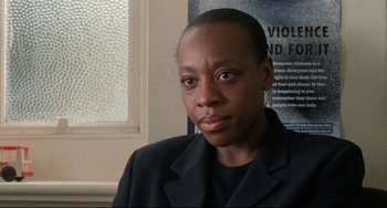 Movie still from “Secrets & Lies” (1996), directed by Mike Leigh – A woman wearing a black jacket and a black shirt; Close Up shot, High angle