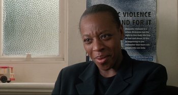 Movie still from “Secrets & Lies” (1996), directed by Mike Leigh – A person wearing a black jacket and a black shirt; Close Up shot, High angle