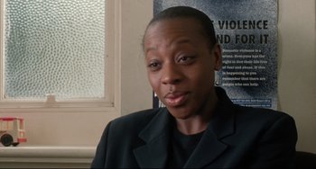 Movie still from “Secrets & Lies” (1996), directed by Mike Leigh – A woman in a black jacket is looking at the camera; Close Up shot, High angle