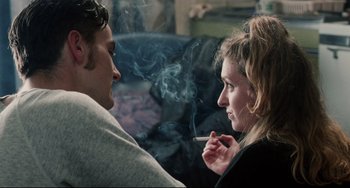 Movie still from “Secrets & Lies” (1996), directed by Mike Leigh – A man and a woman are smoking a cigarette together; Close Up shot, Over the shoulder angle