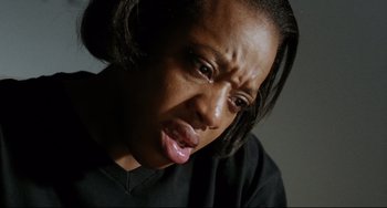 Movie still from “Secrets & Lies” (1996), directed by Mike Leigh – A person making a funny face; Close Up shot, High angle