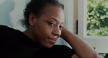Movie still from “Secrets & Lies” (1996), directed by Mike Leigh – A person leaning on a wall; Close Up shot, Low angle
