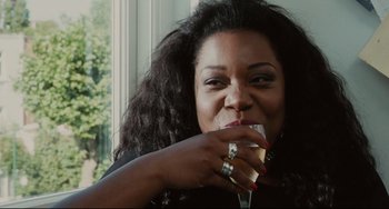 Movie still from “Secrets & Lies” (1996), directed by Mike Leigh – A person holding a glass of wine; Close Up shot, Over the shoulder angle