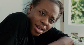 Movie still from “Secrets & Lies” (1996), directed by Mike Leigh – A person wearing a black t - shirt; Close Up shot, Low angle