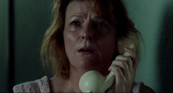 Movie still from “Secrets & Lies” (1996), directed by Mike Leigh – A person talking on a phone; Close Up shot, Low angle