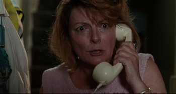 Movie still from “Secrets & Lies” (1996), directed by Mike Leigh – A woman holding a phone up to her ear; Close Up shot, High angle