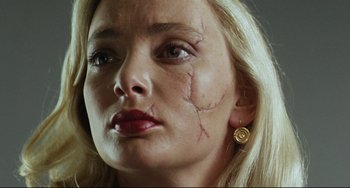 Movie still from “Secrets & Lies” (1996), directed by Mike Leigh – A person with scars on her face; Extreme Close Up shot, Low angle