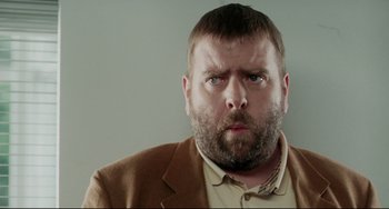 Movie still from “Secrets & Lies” (1996), directed by Mike Leigh – A person wearing a suit and tie; Close Up shot, Low angle