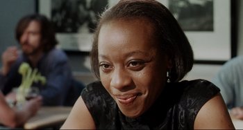Movie still from “Secrets & Lies” (1996), directed by Mike Leigh – A person smiling for the camera; Close Up shot, Over the shoulder angle