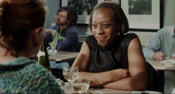 Movie still from “Secrets & Lies” (1996), directed by Mike Leigh – A woman sitting at a table in front of two glasses of wine; Close Up shot, Over the shoulder angle