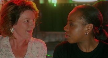 Movie still from “Secrets & Lies” (1996), directed by Mike Leigh – Two women are talking to each other at a party; Close Up shot, Over the shoulder angle