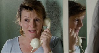 Movie still from “Secrets & Lies” (1996), directed by Mike Leigh – A woman holding a phone up to her ear; Close Up shot, High angle