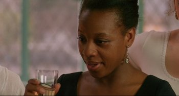 Movie still from “Secrets & Lies” (1996), directed by Mike Leigh – A person holding a glass of wine; Close Up shot, Over the shoulder angle