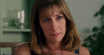 Movie still from “Secrets & Lies” (1996), directed by Mike Leigh – A person with her hand on her chest; Close Up shot, Over the shoulder angle