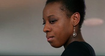 Movie still from “Secrets & Lies” (1996), directed by Mike Leigh – A person wearing a black shirt and a pair of earrings; Close Up shot, Low angle