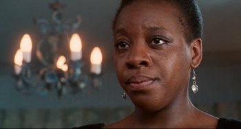 Movie still from “Secrets & Lies” (1996), directed by Mike Leigh – A person with a candle in the background; Close Up shot, Low angle
