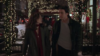 Movie still from “Serendipity” (2001), directed by Peter Chelsom – A man and a woman walking down a street; Medium shot, Over the shoulder angle