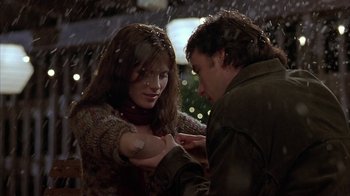 Movie still from “Serendipity” (2001), directed by Peter Chelsom – A man and a woman holding hands in the snow; Close Up shot, Over the shoulder angle