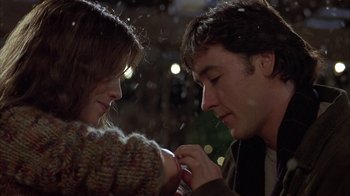 Movie still from “Serendipity” (2001), directed by Peter Chelsom – A man and a woman looking at each other; Close Up shot, Over the shoulder angle
