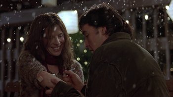 Movie still from “Serendipity” (2001), directed by Peter Chelsom – A man and a woman looking at a cell phone; Close Up shot, Over the shoulder angle