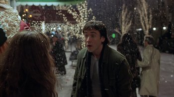 Movie still from “Serendipity” (2001), directed by Peter Chelsom – A man standing in the snow looking surprised; Medium shot, Over the shoulder angle