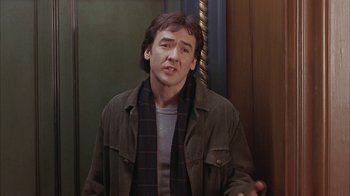 Movie still from “Serendipity” (2001), directed by Peter Chelsom – A man in a brown jacket is talking to someone; Medium shot, Over the shoulder angle