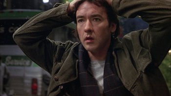 Movie still from “Serendipity” (2001), directed by Peter Chelsom – A person holding his head with his hands; Close Up shot, Over the shoulder angle