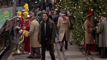 Movie still from “Serendipity” (2001), directed by Peter Chelsom – A crowd of people walking down a street; Medium shot, Over the shoulder angle